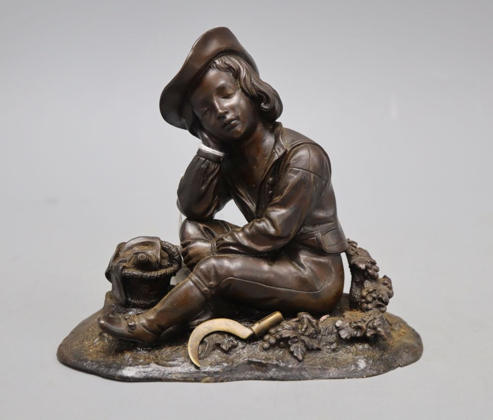 A mid 19th century bronze of a boy seated in a grapevine with a hand sickle, height 14cm